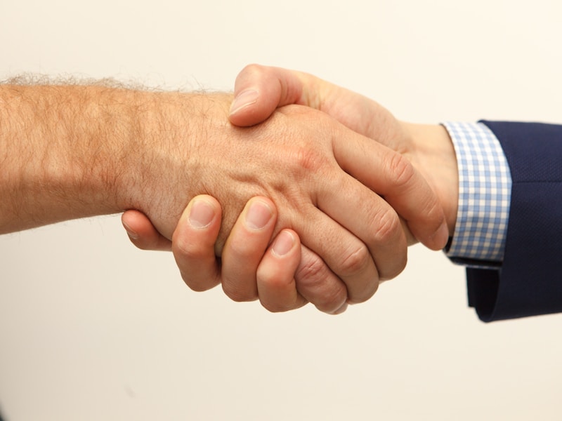 Professional handshake representing business transition
